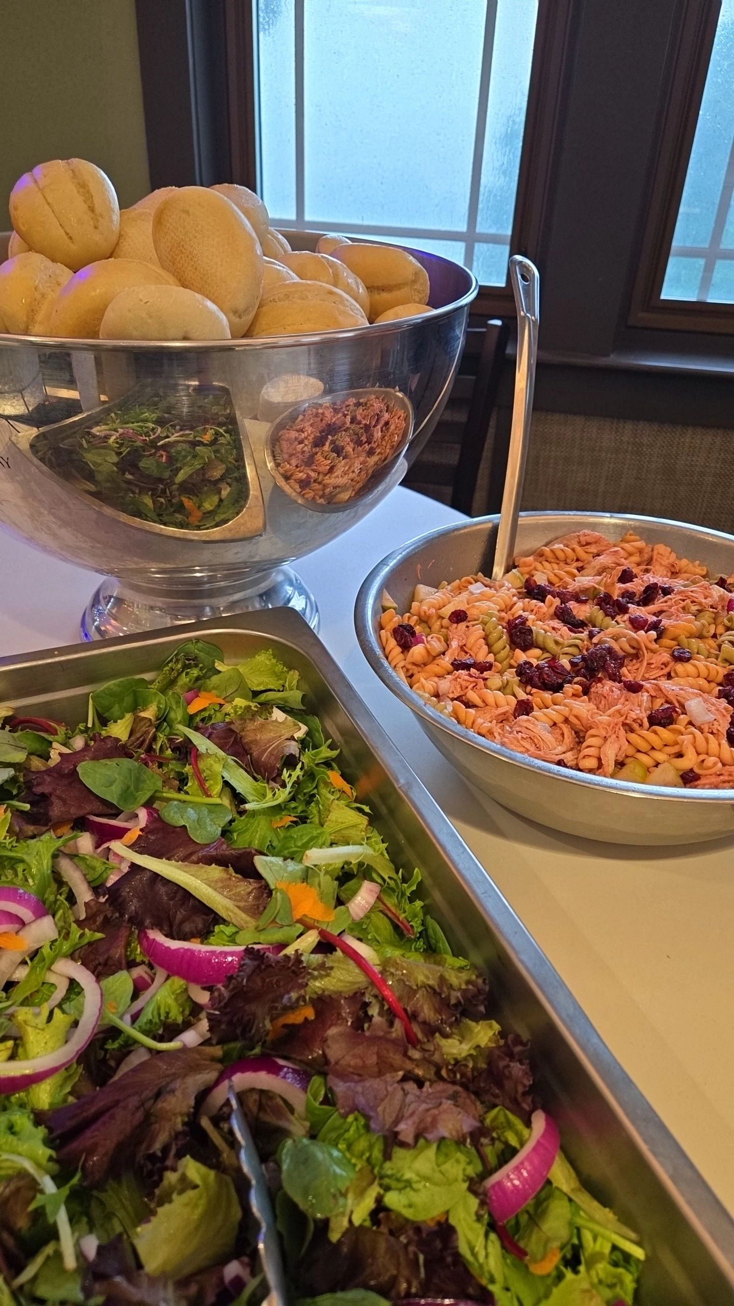 Buffet spread with bread rolls and salads